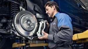 Ford Tech Working On Tire