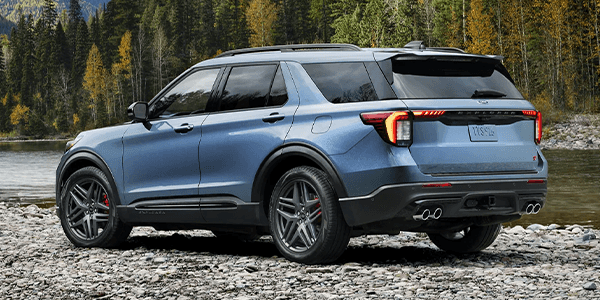 Blue Ford SUV near the water