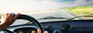 hands on steering wheel looking over the dashboard