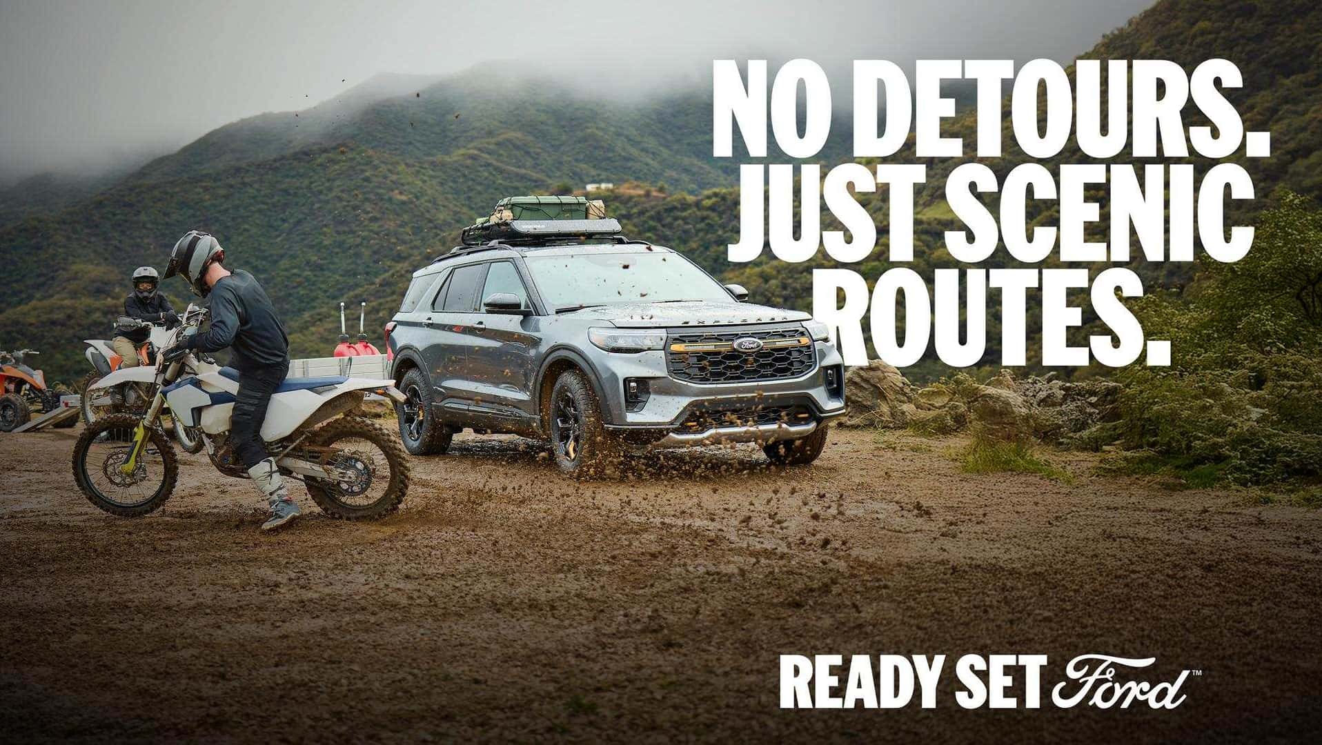 2026 Ford Explorer Tremor driving with dirt bikes on a rugged trail