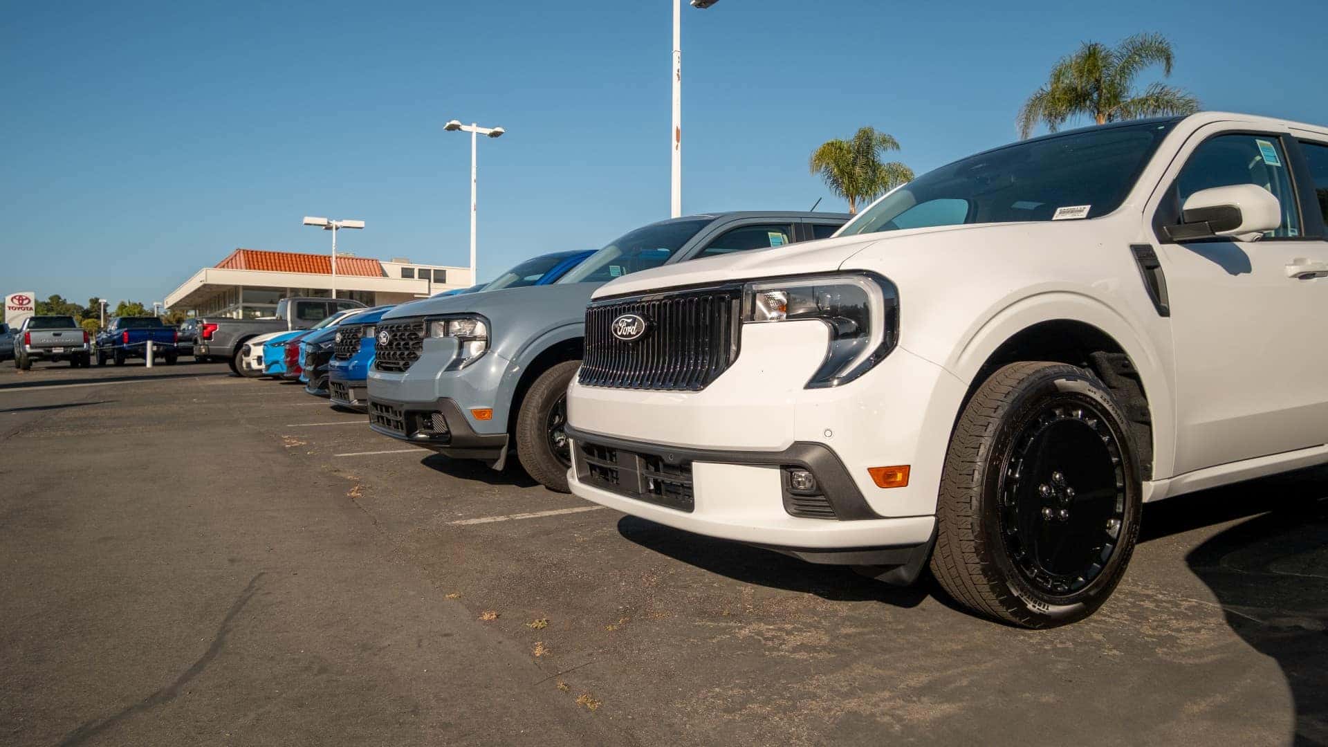 Ford trucks lined up at dealership lot in Southern California