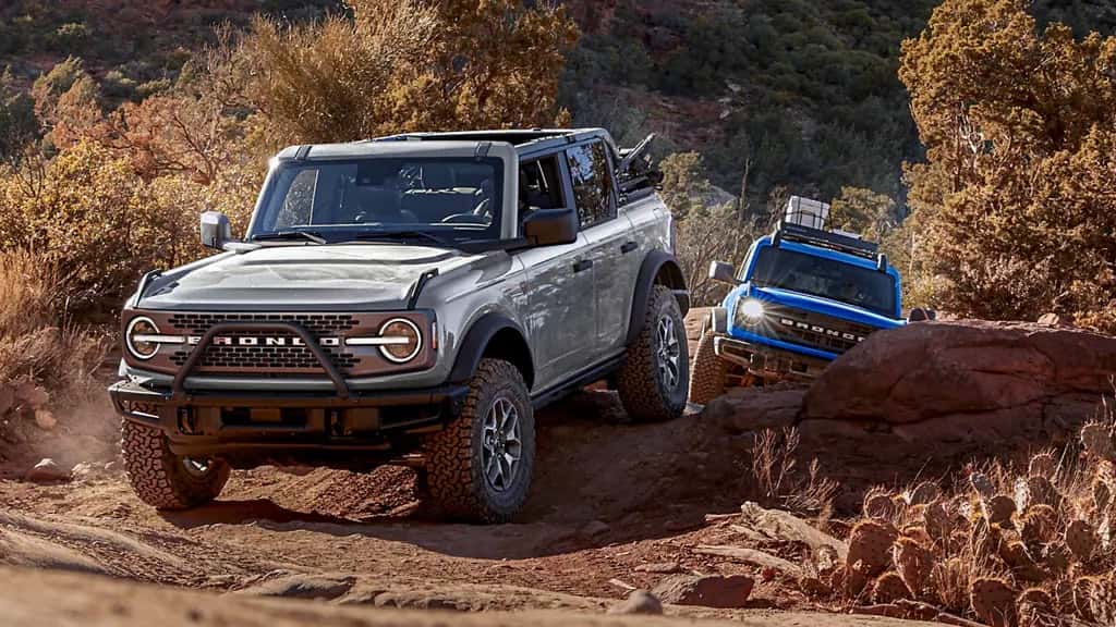 2023 Ford Broncos driving through a rock path