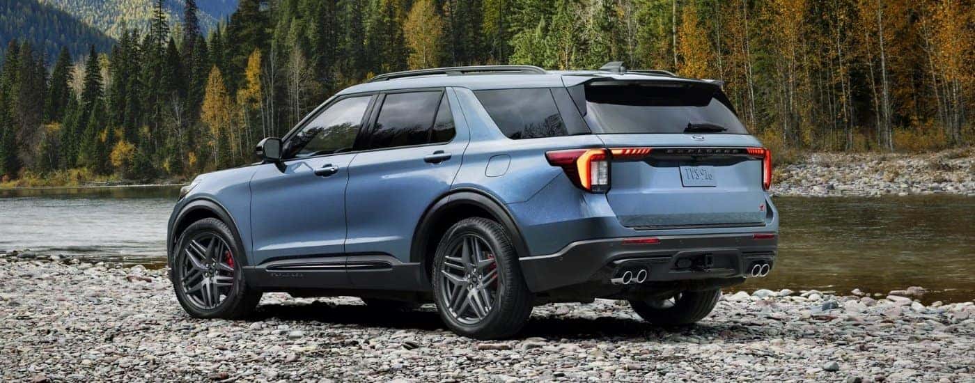 Blue 2026 Ford Explorer ST parked by a river