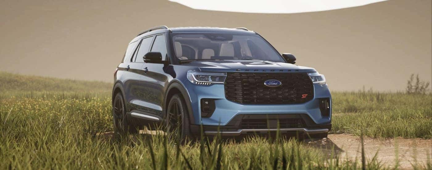 Blue 2026 Ford Explorer ST parked in tall grass
