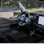 Interior view of a 2026 Ford F-150 showing the dashboard, touchscreen display, and dark leather seats.