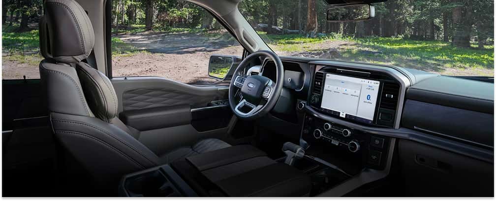 Interior view of a 2026 Ford F-150 showing the dashboard, touchscreen display, and dark leather seats.