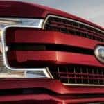Closeup of the grille on a red 2020 Ford F-150 from a used Ford F-150 dealer.