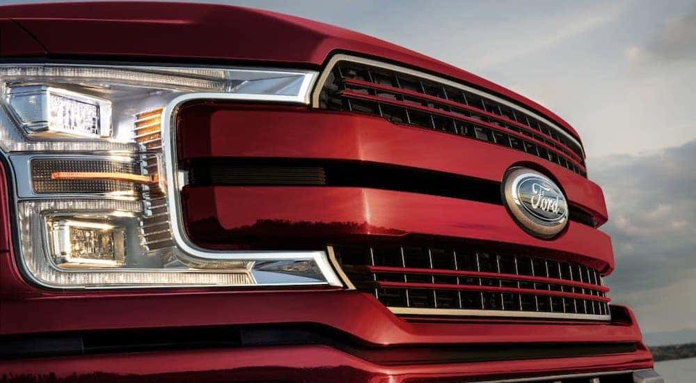 Closeup of the grille on a red 2020 Ford F-150 from a used Ford F-150 dealer.