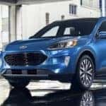 A blue 2021 Ford escape is parked in a Ford Escape dealership.