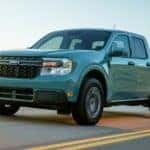 Side view of a blue Ford Maverick XLT driving on the highway near Canon City, CO