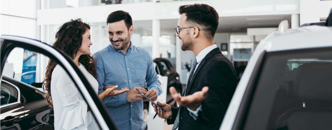 A salesman and customers are shown at a build to order Ford dealership.