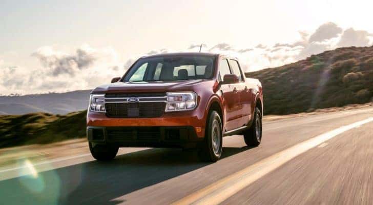 A red 2022 Ford Maverick Lariat is shown on a sunny day after leaving a Ford truck dealer near you.