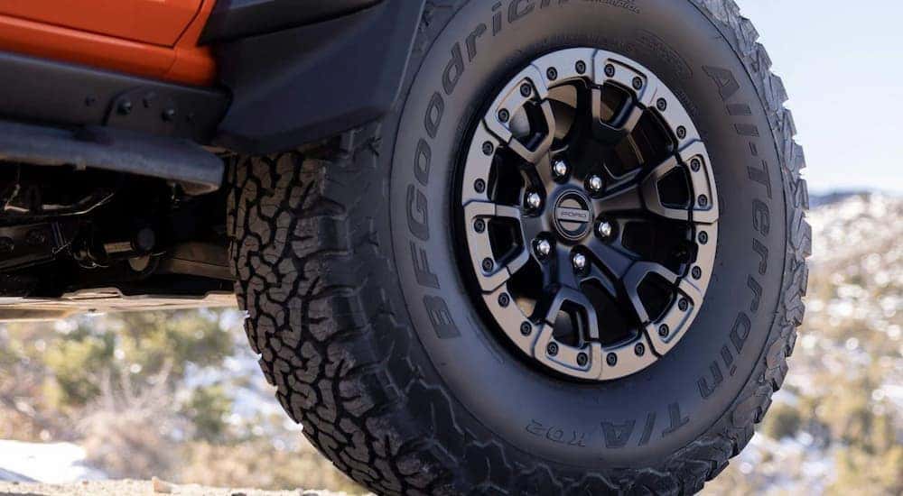 A close up of the tire on a 2022 Ford Bronco Raptor is shown parked at a Ford Bronco dealer near you.