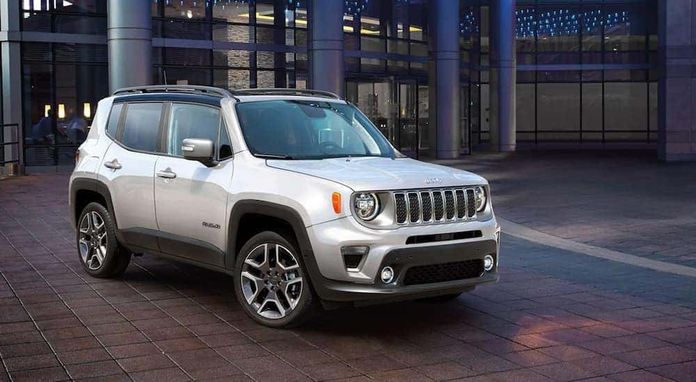 A silver 2021 Jeep Renegade Limited is shown parked on a city street.