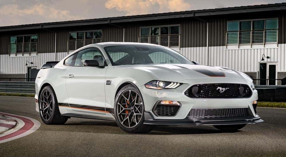A grey 2022 Ford Mustang Mach-1 is shown from the front at an angle on a racetrack.
