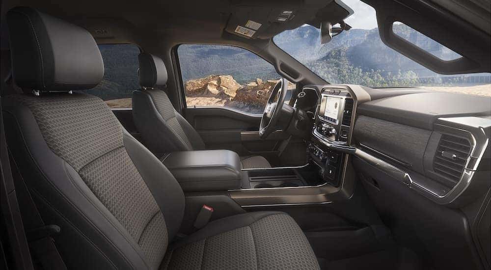 The interior of a 2023 Ford F-150 Rattler is shown from the passenger side door opening.