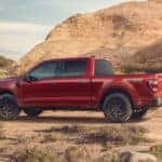 A red 2023 Ford F-150 Rattler is shown from the side while parked off-road after leaving a Ford F-150 dealer near Florence, CO.