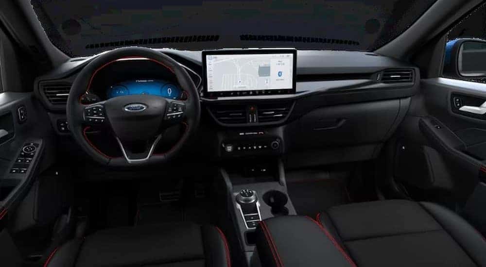 The black interior and dash of a 2023 Ford Escape ST-Line Elite is shown.