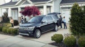 A black 2023 Ford Expedition Platinum is shown parked in a driveway.