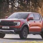 A orange 2024 Ford Ranger Raptor is shown from the front at an angle.