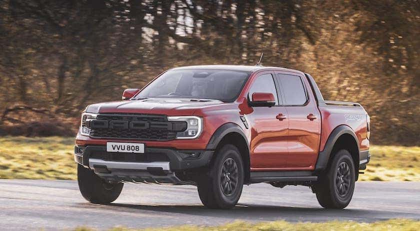 A orange 2024 Ford Ranger Raptor is shown from the front at an angle.