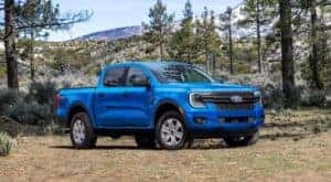 A blue 2024 Ford Ranger XL STX is shown from the front at an angle after leaving a dealer that has Ford trucks for sale.