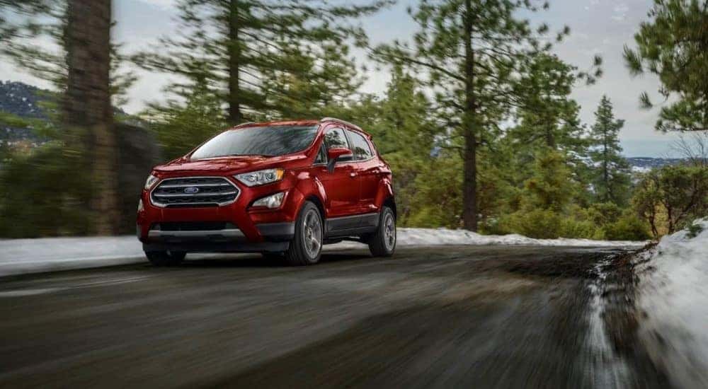 A red 2021 Ford EcoSport is shown driving.