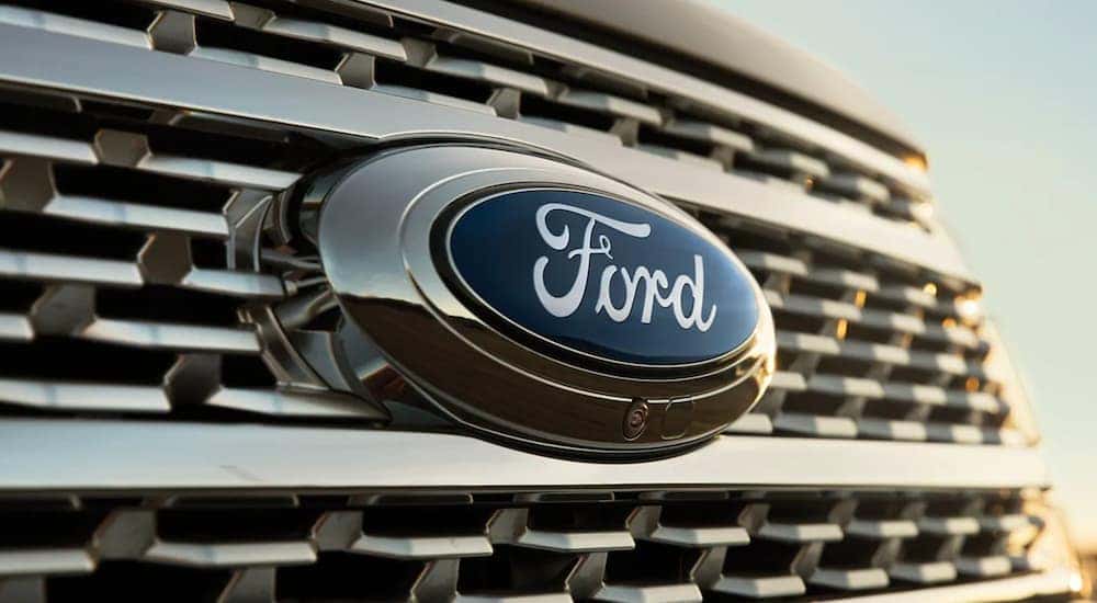 A close-up on the badge of one of the most common used SUVs for sale, a black 2021 Ford Expedition, is shown.