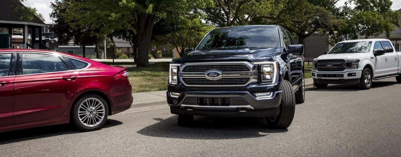 A black 2023 Ford F-150 is shown pulling out of a parking space.