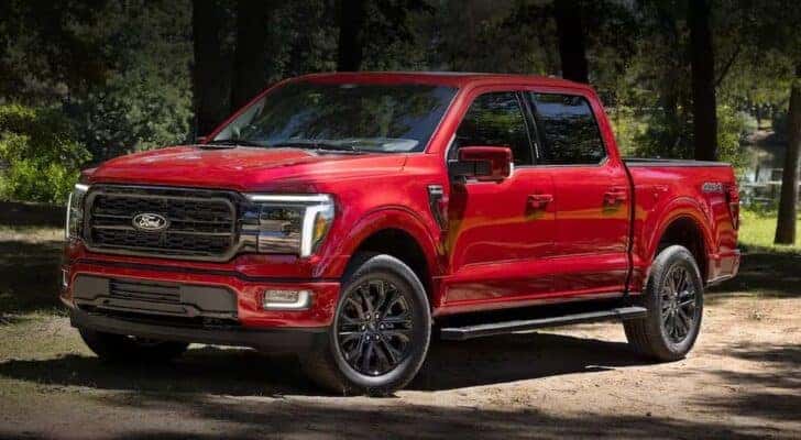 A red 2024 Ford F-150 XLT is shown parked by a dealer with the Ford F-150 for sale near Pueblo West.