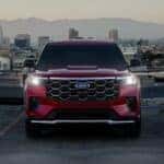 A red 2025 Ford Explorer Platinum is shown parked near a Ford dealer near Colorado Springs.