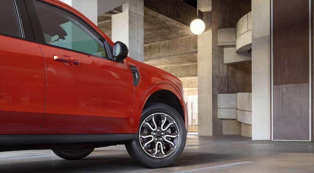 A red 2024 Ford Maverick is parked at a Ford dealer near Custer County. 