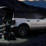 Two people loading gear into the back of a white 2024 Ford Bronco Sport Big Bend.