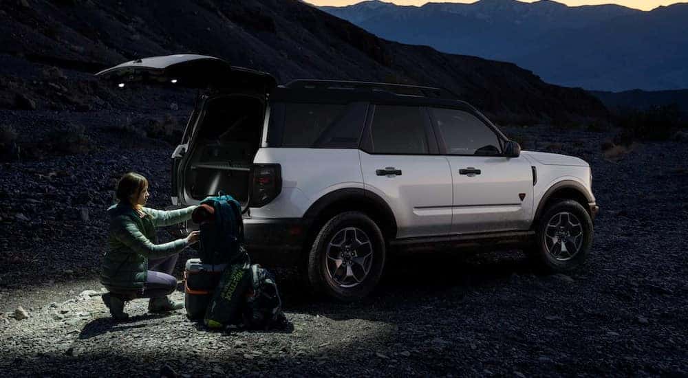 Two people loading gear into the back of a white 2024 Ford Bronco Sport Big Bend.