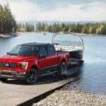 A red 2023 Ford F-150 XLT Heritage Edition is shown from the front while loading a boat.