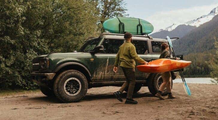 A green 2025 Ford Bronco Badlands is shown parked off-road.