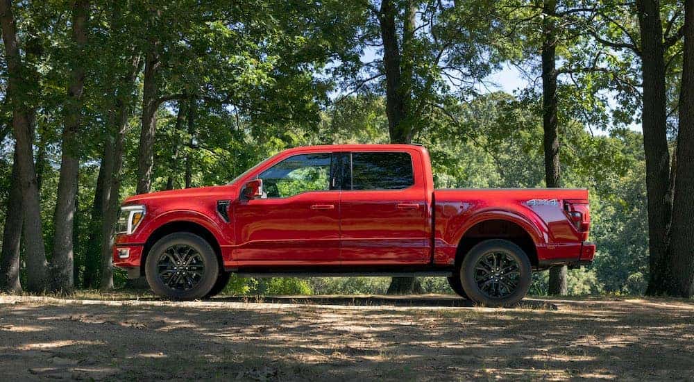 A red 2024 ford F-150 Lariat is shown from the side.