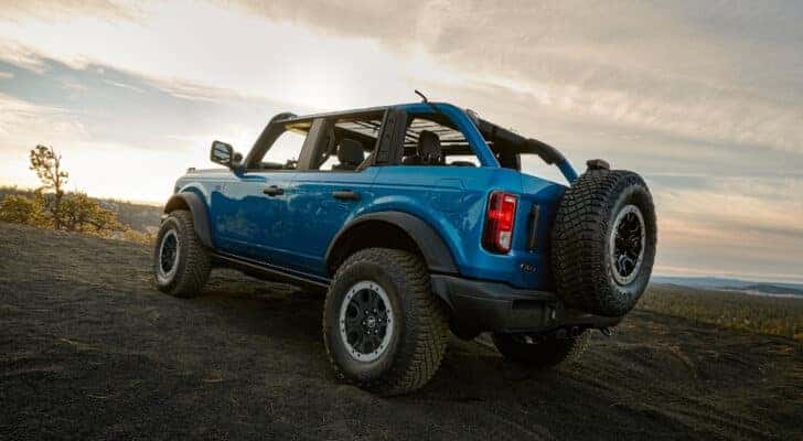 A blue 2025 Ford Bronco for sale is shown from the rear at an angle.