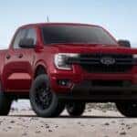 A red 2025 Ford Ranger for sale is shown parked off-road.