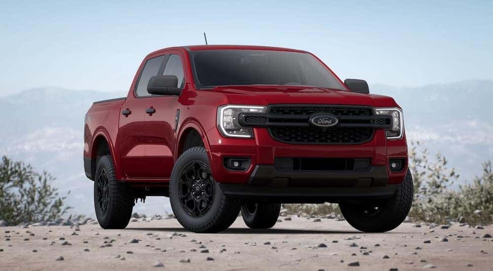 A red 2025 Ford Ranger for sale is shown parked off-road.