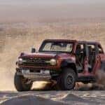 A red 2025 Ford Bronco Raptor from the front.