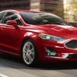 A red 2020 Ford Fusion from the front at an angle.