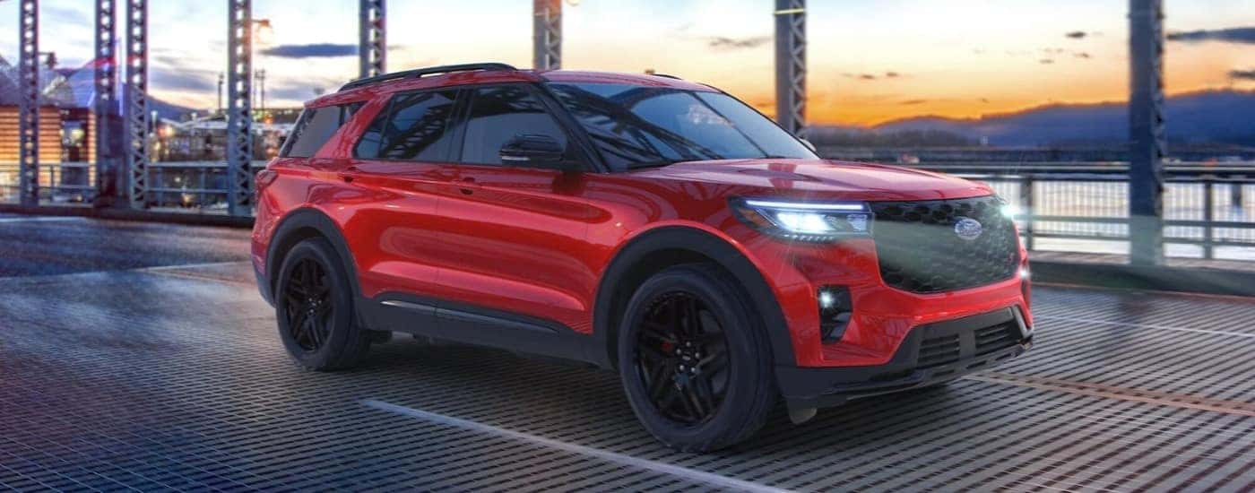 A red 2025 Ford Explorer ST driving on a bridge