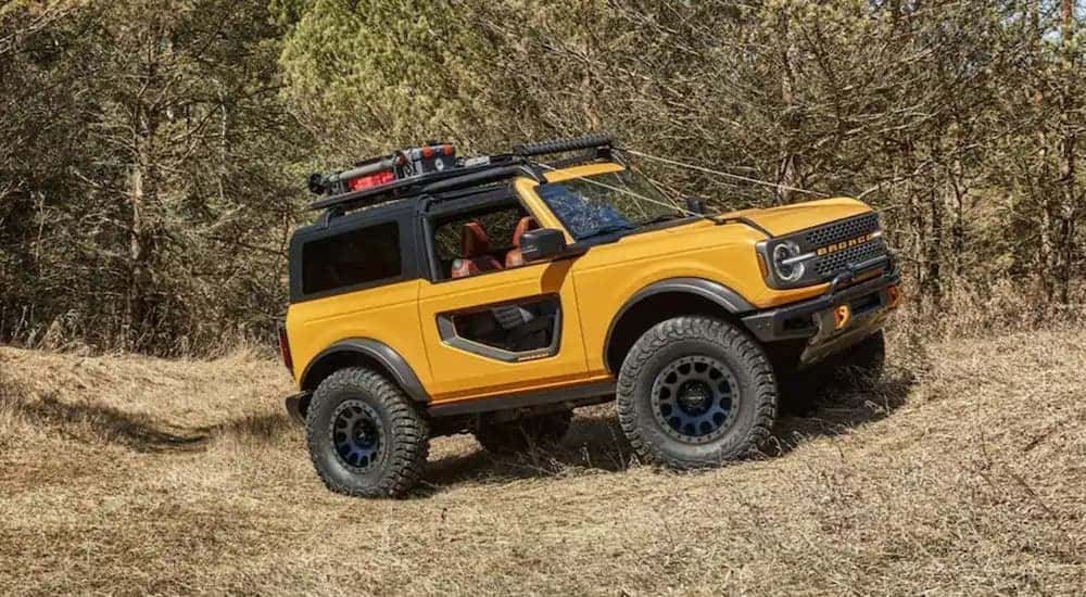 An orange 2021 Ford Bronco parked off-road.