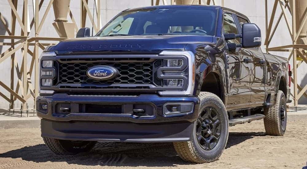 A black 2024 Ford F-250 parked on a construction site.