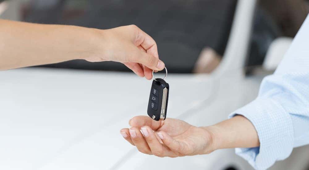 A key is exchanged between two people.