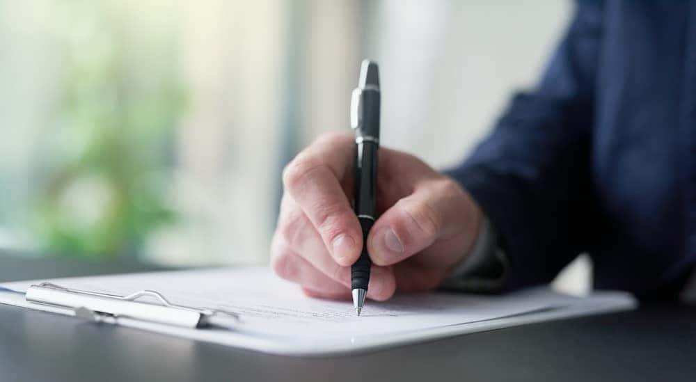 A person signing paperwork.