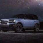 A silver 2024 Ford Bronco Sport parked under a starry sky