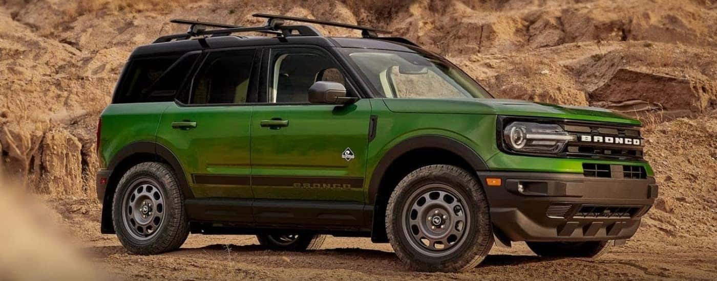 A green 2023 Ford Bronco Sport Outer Banks parked off-road.