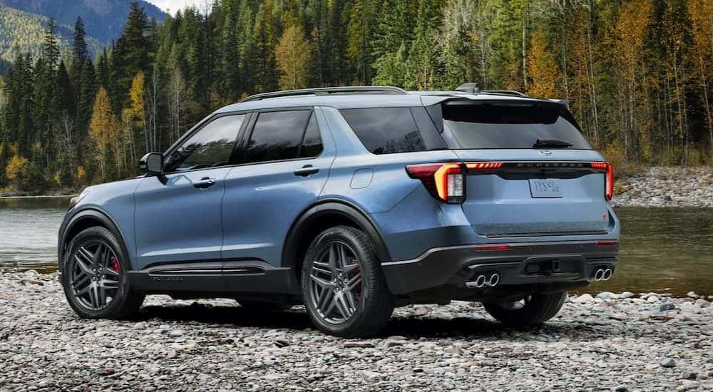 A blue 2024 Ford Exploer ST-Line parked off-road after visiting a used car dealer.